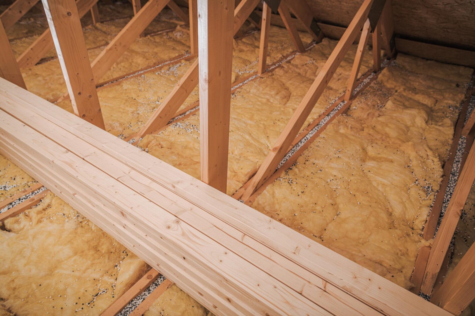 closeupofinsulationlaidinatticofhouse